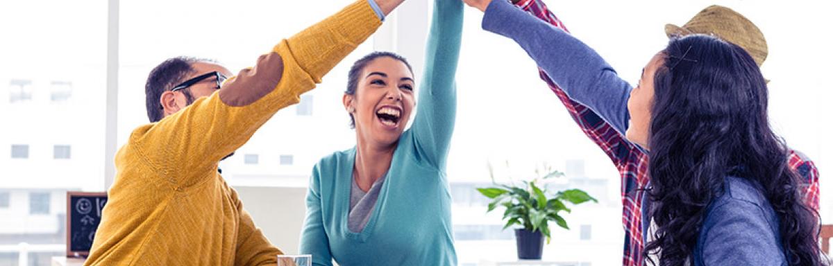 Enthusiastic office workers performing high-five
