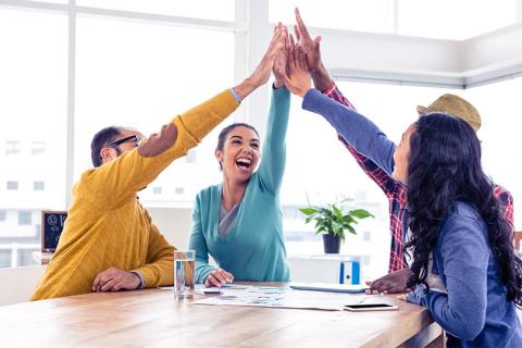 Enthusiastic office workers performing high-five